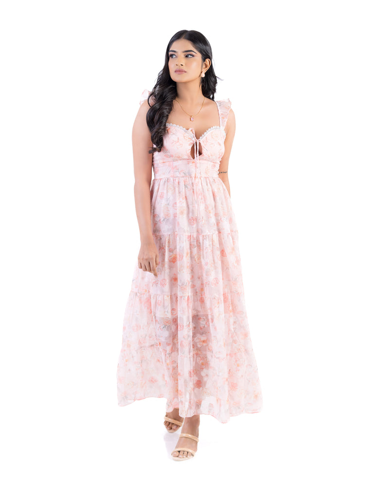 Model wearing the Floral Breeze Midi Dress in pink highlighting the romantic floral print and flowy midi style